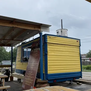 View of the trailer from underneath the other covered seating area.