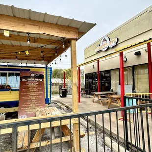a yellow bus parked in front of a restaurant