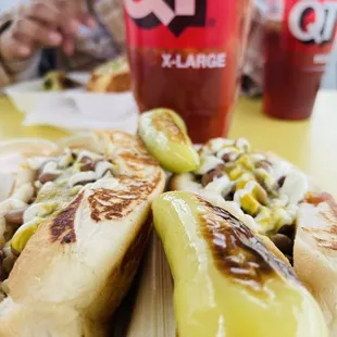 a hot dog with cheese and pickles