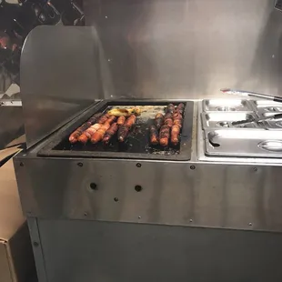 a bunch of hotdogs being cooked