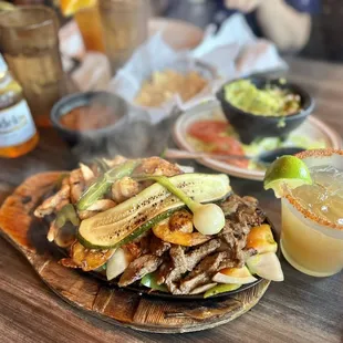 Trio fajitas rice, beans and tortillas not pictured but it comes with it too. Drink was a Tamarindo Margarita