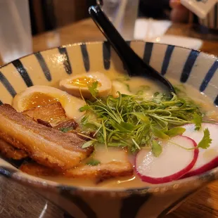 a bowl of ramen with meat and vegetables