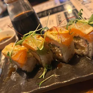 LAURA&apos;S ROLL: Salmon, Shrimp, Crab, Avocado, Cucumber, Lemon Slices, Chiles Toreados, Ponzu, Cilantro.