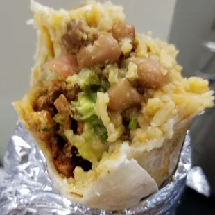 Pastor super burrito. Had bits of pineapple at the end of it. Small surprise.