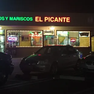 cars parked in front of a mexican restaurant