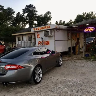 a car parked in front of a taqueria