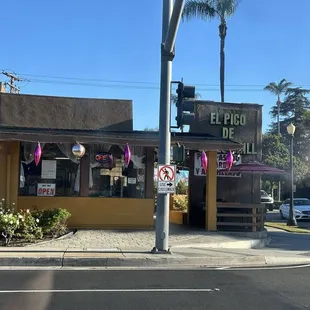 Outside.  Man is grilling outside. Smells good