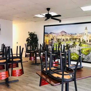 a dining room with chairs and a television