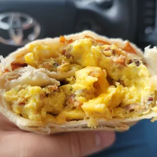 Breakfast burrito with egg, cheese, bacon, and shredded hash browns