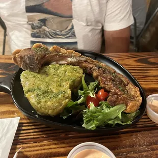 Chuleta Kan Kan with side of salad and mofongo