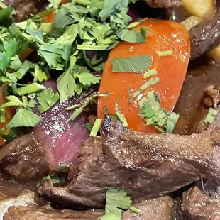 a plate of beef and vegetables