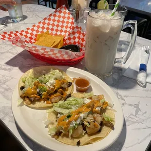 Fish tacos with a large horchata