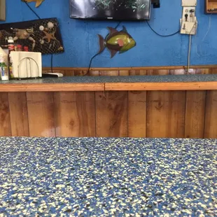 a tv mounted on a blue wall