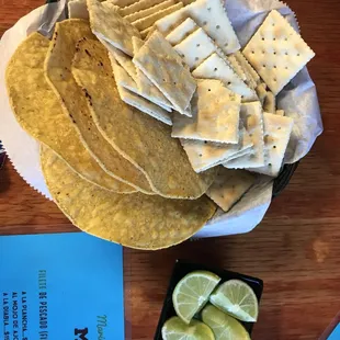 a plate of tortillas and lime slices