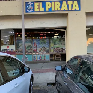 two cars parked in front of a restaurant