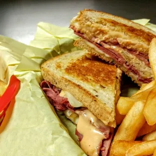 Reuben sandwich with a side of fries