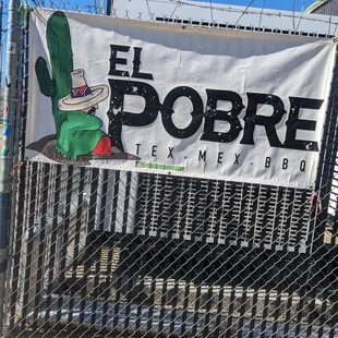 Sign in front of the parking area for the food truck