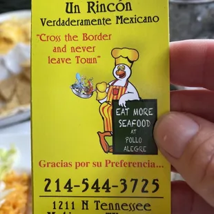 a hand holding a restaurant menu