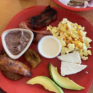 Breakfast plate  Platano maduro aguacate quedo mantequilla two eggs of your choice steak chorizo beans and queso