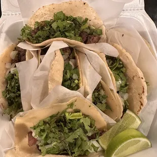 three tacos in a styrofoam container