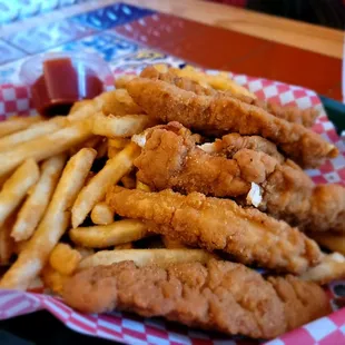 a basket of fried fish and fries