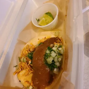 Chicken taco with lime, salsa, onion and cilantro