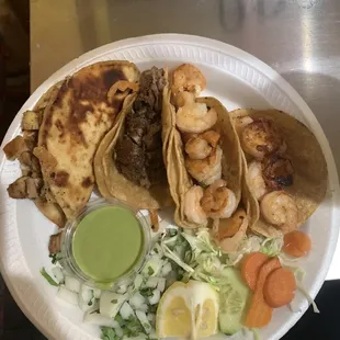 My plate chicken chalupa, taco de tripas and 2 shrimp tacos you add the salsas you want to them.
