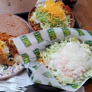 5 rolled tacos with cotija, hard taco beans and rice, and a chicken salad bowl