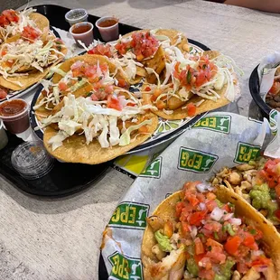 Fish tacos to the left, and chicken &amp; carne asada tacos on the right.