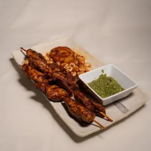Anticuchos de Pollo. Chicken skewers marinated in house made sauce. 
Available during HAPPY HOUR for $10