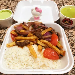a tray of food with rice and vegetables