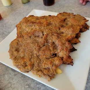 Their beef milanesa is as large as a hubcap and made with ribeye!  Underneath, sweet plantain and French fries.   Wonderful!