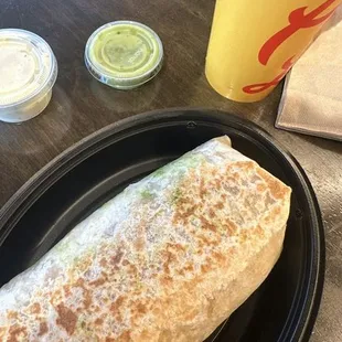Queso guacamole burrito great an cheesy I love it with the creamy cilantro and avocado salsa