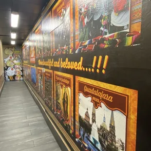 a long corridor with posters on the walls