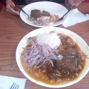 Seco de Cordero con Frijoles. Y salsa  Criolla. Lamb stew with beans rice Peruvian red onions slaw. El Pollo Peruano, Carson