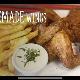 a plate of chicken wings and french fries
