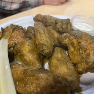 a plate of chicken wings and carrots