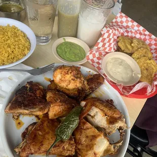 Whole Chicken half not spicy half spicy with rice and tostones.