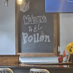 a chalkboard with a welcome to e pollon written on it
