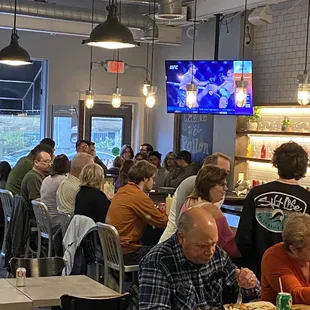 a large group of people sitting at tables in a restaurant