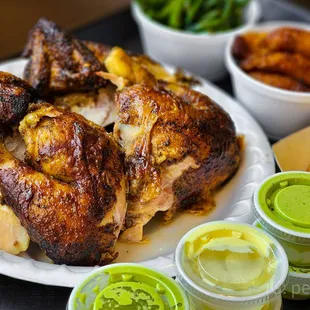 a plate of roasted chicken and sides
