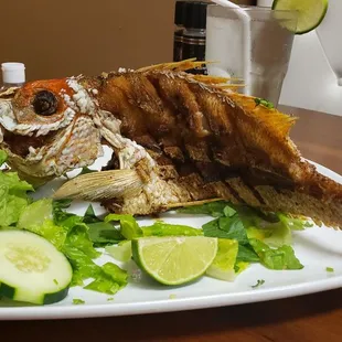 Whole fried fish and salad