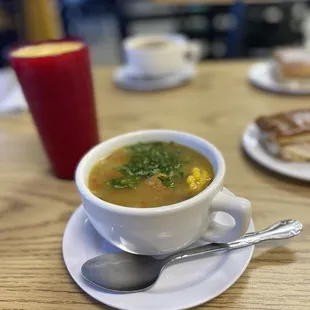 a bowl of soup and a plate of toast