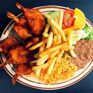 Fried shrimp, fries, rice, and beans