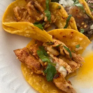 three tacos on a paper plate