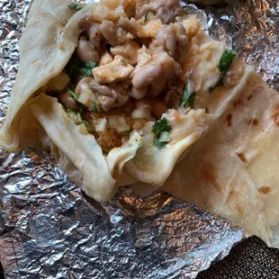 a burrito wrapped in aluminum foil
