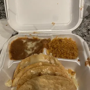 2 crispy chicken tacos no lettuce with refried beans and rice