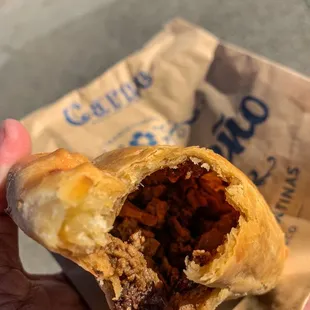 Carne Empanada (traditionally prepared ranch beef, onions, green olives, raisins, and cage-free hard boiled egg)... Delicious!