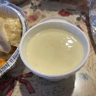 a bowl of soup and a plate of tortillas