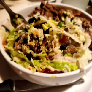a bowl of food with a fork in it